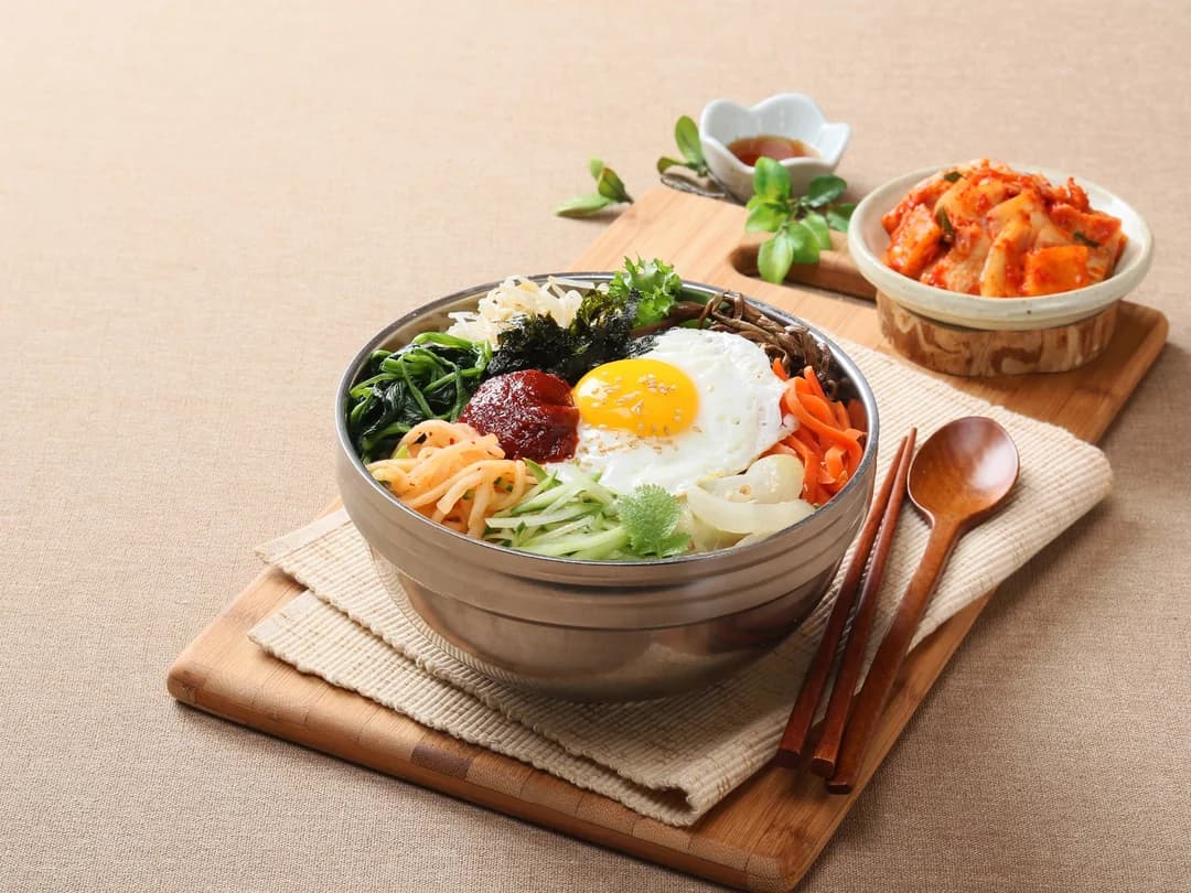 Bibimbap: rice topped with seasoned vegetables, a fried egg and kimchi